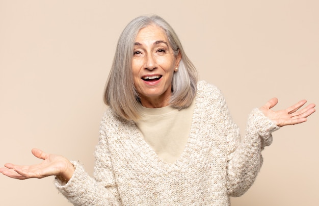 Photo middle age woman looking happy, arrogant, proud and self satisfied, feeling like a number one