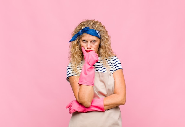 Middle age woman looking serious, confused, uncertain