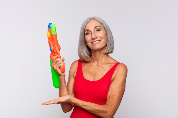 Middle age woman smiling cheerfully, feeling happy isolated