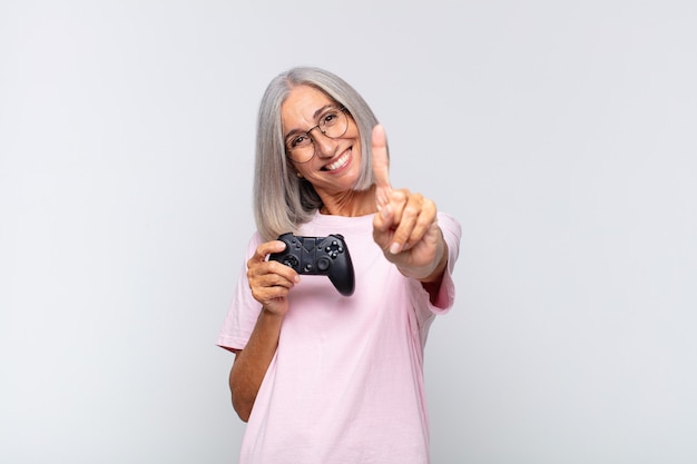 Middle age woman smiling and looking friendly isolated