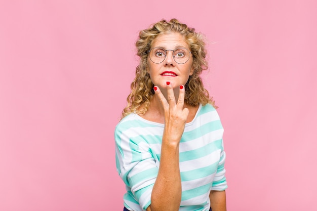 Middle age woman smiling and looking friendly