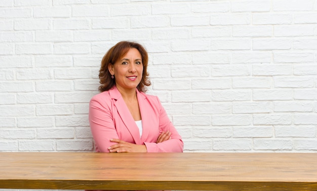 Middle age woman smiling with crossed arms