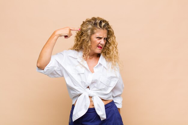 Middle age woman with long curly hair isolated