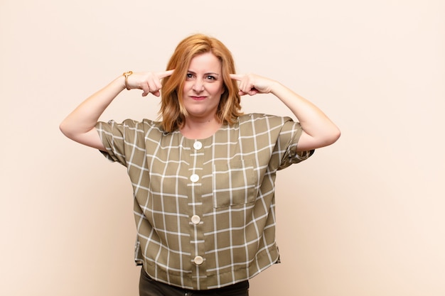 Middle age woman with a serious and concentrated look, brainstorming and thinking about a challenging problem