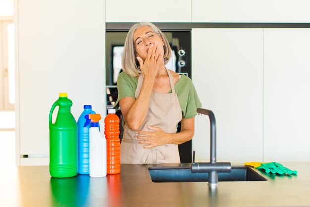 Middle age woman yawning lazily early in the morning, waking and looking sleepy, tired and bored