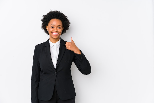 Middle aged african american business  woman against a white isolated smiling and raising thumb up