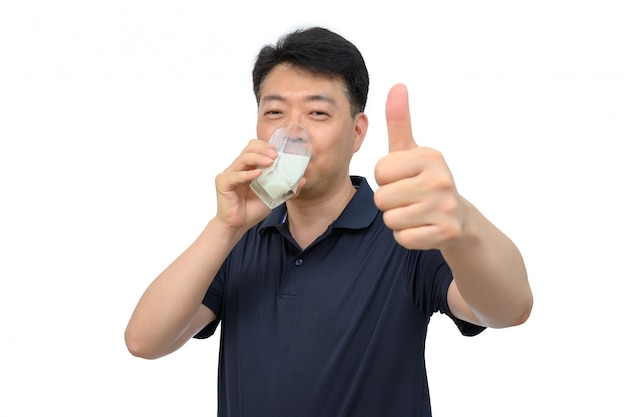 middle-aged Asian man is drinking a fresh glass of milk on white