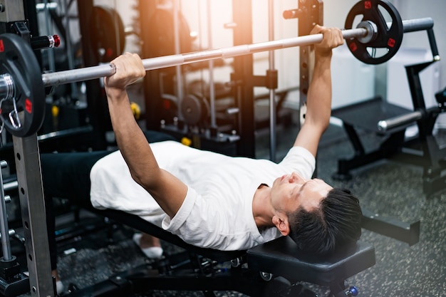 Middle-aged asian man training in the gym