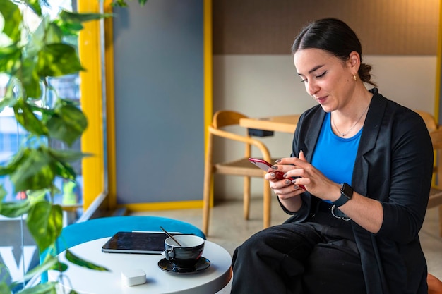 Middle aged business woman looking at phone