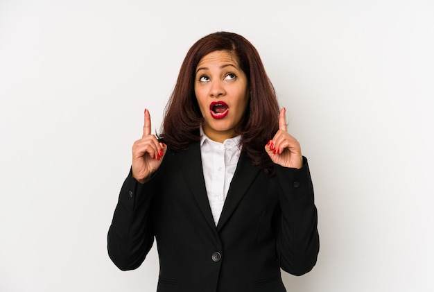 Middle aged business woman pointing upside with opened mouth