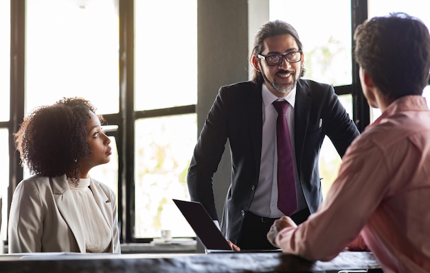 Middle aged businessman have meeting with international team at office