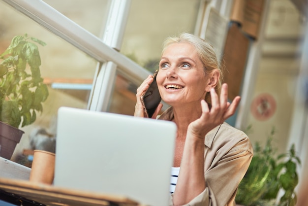 Middle aged caucasian business woman talking on phone