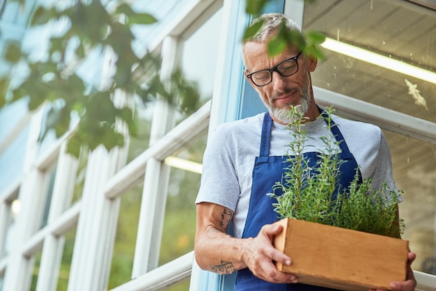 Middle aged caucasian man with spicy herbs in box