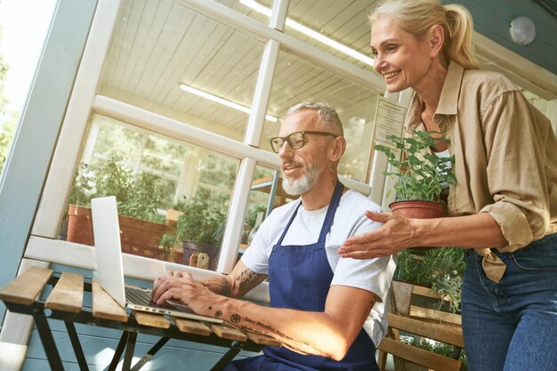 Middle aged caucasian spouses working on computer