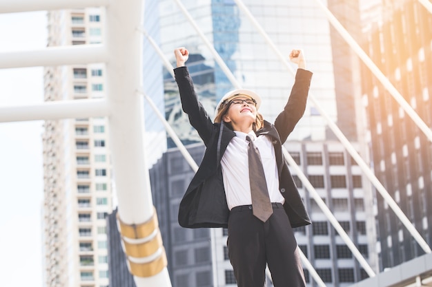 Middle-aged Engineer or architect woman in winner pose