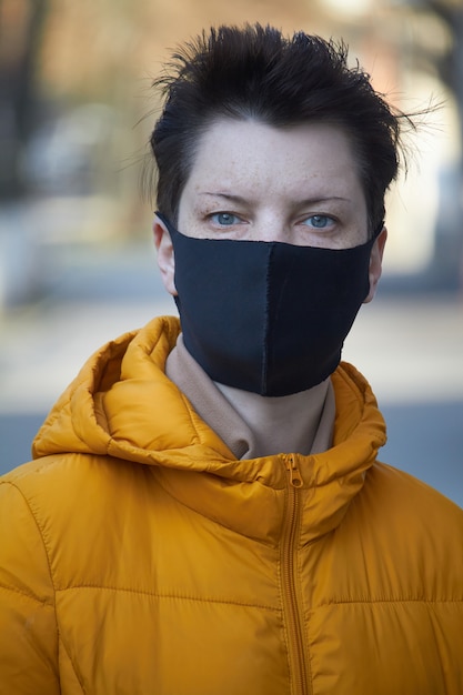 Middle aged european woman in protective black mask