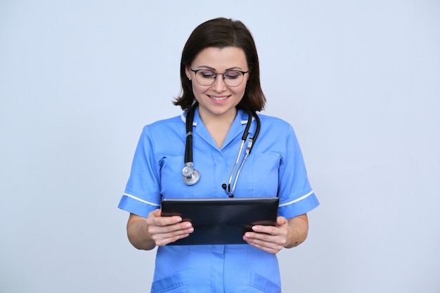 Middle-aged female medical worker with digital tablet