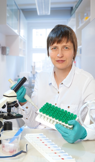 Middle-aged female scientist or tech looks at the viewer