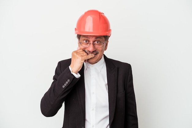 Middle aged indian architect man isolated on white background biting fingernails, nervous and very anxious.