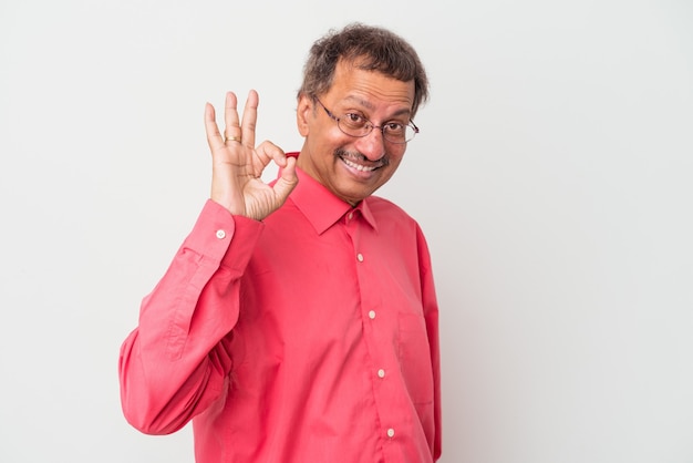 Middle aged indian man isolated on white background cheerful and confident showing ok gesture.