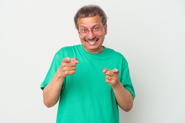 Middle aged indian man isolated on white background pointing to front with fingers.