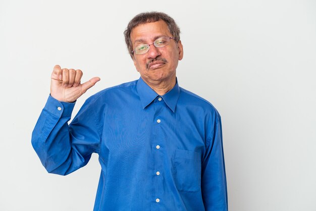 Middle aged indian man isolated on white background showing a dislike gesture, thumbs down. Disagreement concept.