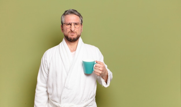 Middle aged man awaking with a coffee cup