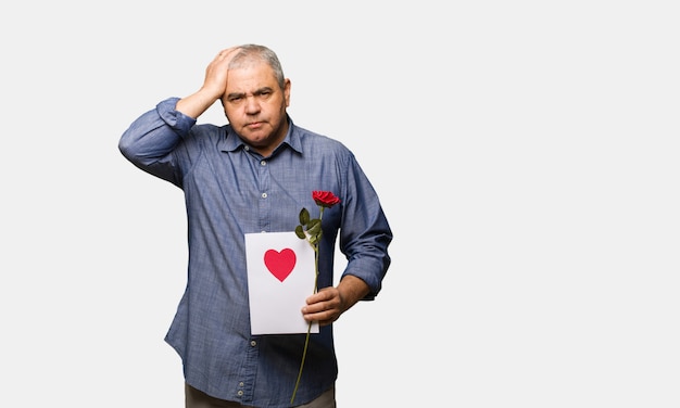 Middle aged man celebrating valentines day worried and overwhelmed