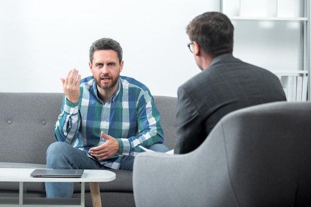 Middle aged man crisis Solving problem Psychology mental therapy concept Man patient and psychologist at psychotherapy session