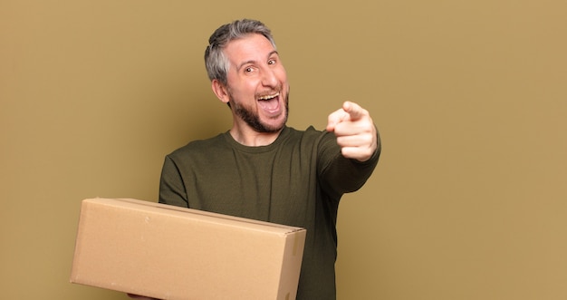 Middle aged man holding a package