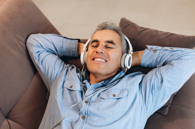 Middle aged man listening to music