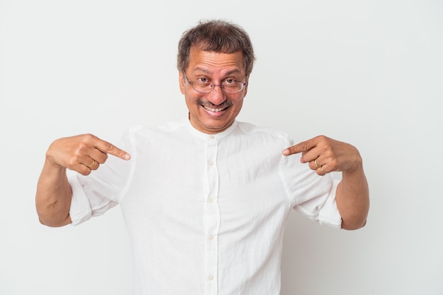 Middle aged man surprised pointing with finger, smiling broadly.