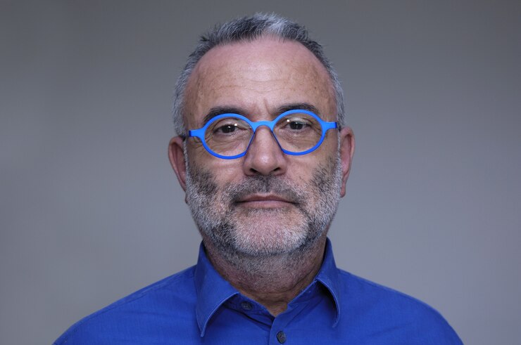 Middle-aged man with blue shirt and glasses