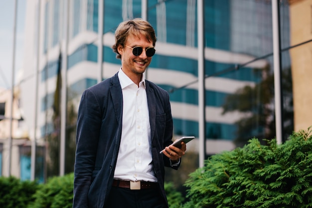 The Middle-aged Manager In A Beautiful Stylish Suit Receives Positive News About The Promotion At Work In A Phone Message