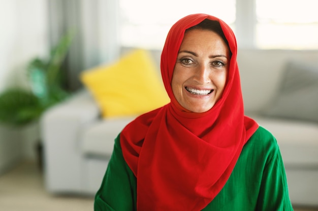 Middle Aged Muslim Woman Wearing Traditional Hijab Sitting At Home