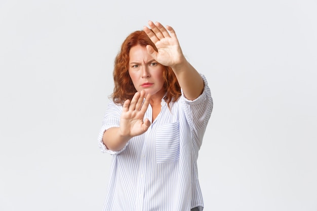 Middle-aged redhead woman posing