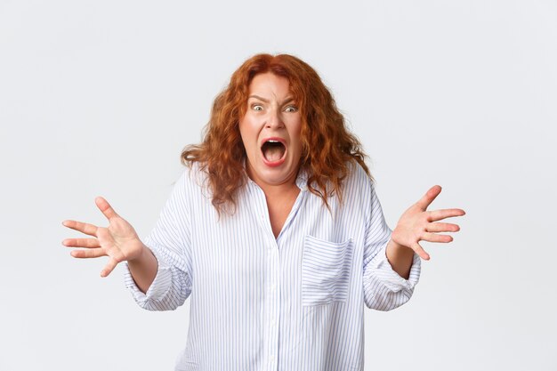 Middle-aged redhead woman posing