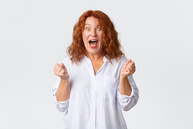 Middle-aged redhead woman posing