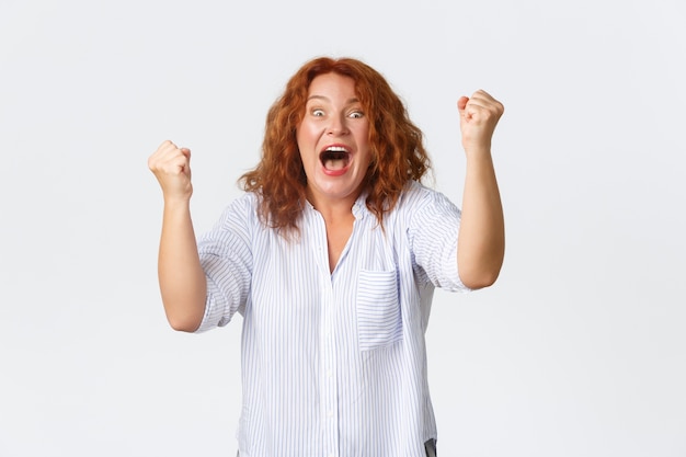 Middle-aged redhead woman posing