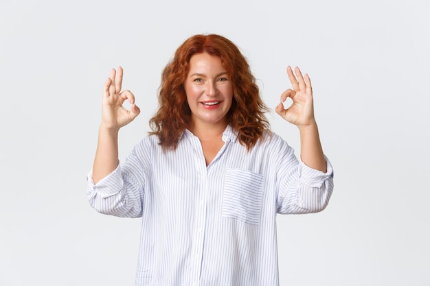 Middle-aged redhead woman posing