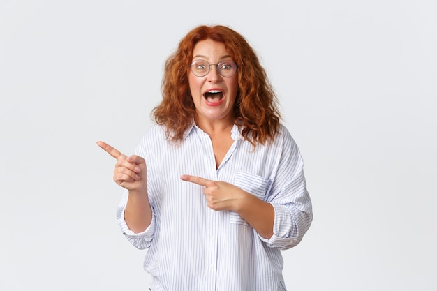 Middle-aged redhead woman posing