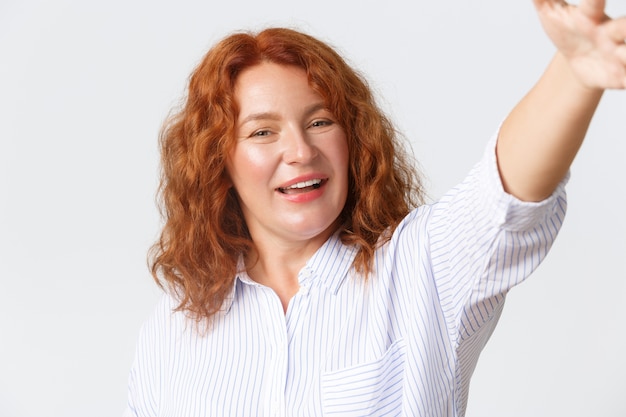 Middle-aged redhead woman posing