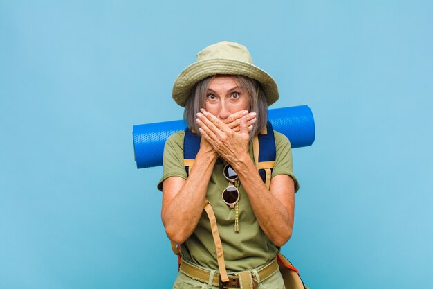 Middle-aged woman covering mouth with hands