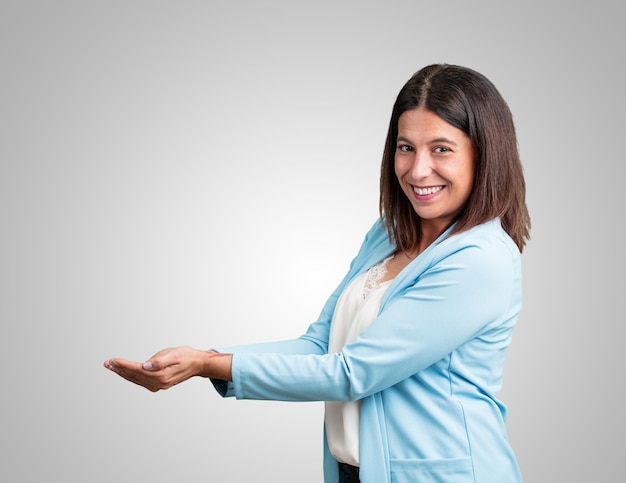 Middle aged woman holding something with hands