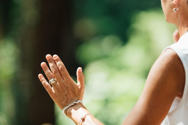 Middle Aged Woman Practicing Tai Chi Chuan in the Park Close Up On Hands Position