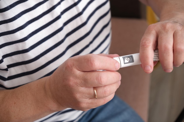 middle aged woman preparing syringe pen with insulin for injection diabetes concept diabetes awareness day November 15