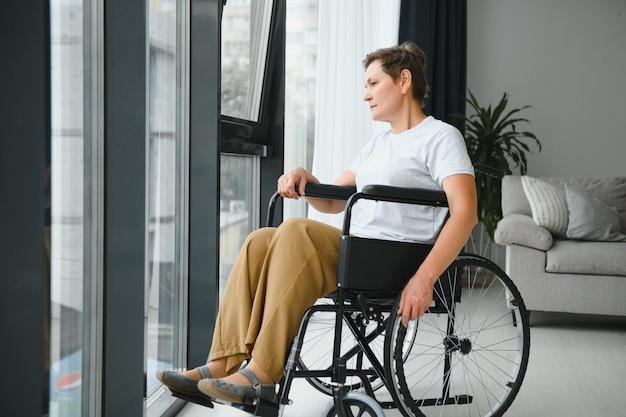 Middle aged woman sitting on wheelchair