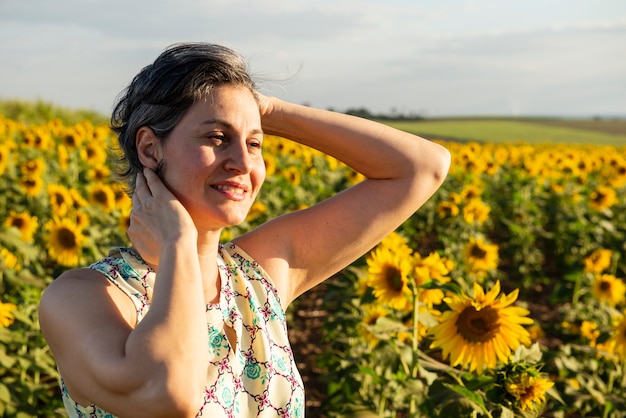 Middle-aged woman in a sunflower plantation