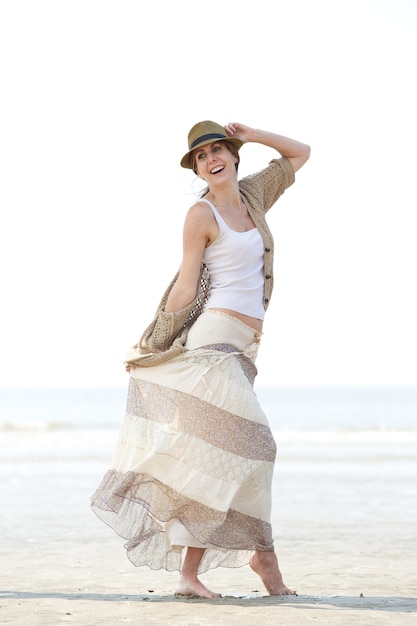 Middle aged woman walking on the beach