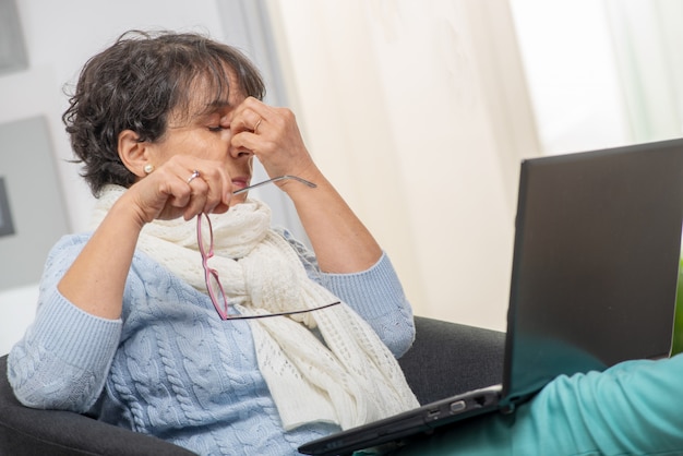 Middle aged woman with stressed out, rubbing her eyes